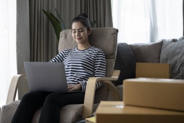 Küçük işletme sahibi dizüstü bilgisayardaki siparişleri kontrol ediyor.