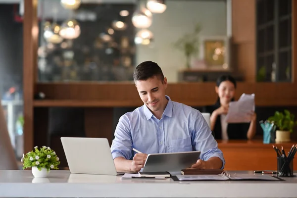Smiling Handsome Businessman Using Digital Tablet Wile Sitting Office — Stockfoto