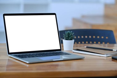 Close up laptop computer with empty display on wooden table.