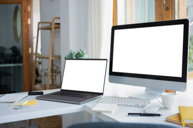 Mockup computer pc and laptop with blank screen on white table.