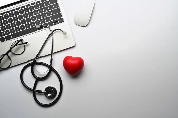Top View Laptop Computer Stethoscope Red Heart White Table Cardiology — Zdjęcie stockowe