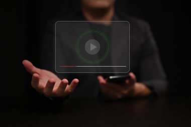 Sanal ekranda çalma düğmesi olan akıllı telefonu tutan adam.