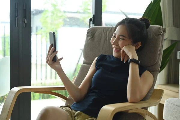 Overjoyed Woman Resting Comfortable Armchair Making Video Call Smart Phone — Stock Photo, Image