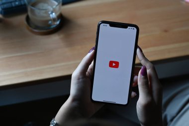 Chiang Mai, Tayland - 01.2022 Mar: YouTube uygulaması olan akıllı telefonu ekranda tutan kadın. YouTube en popüler çevrimiçi video paylaşım sitesidir.