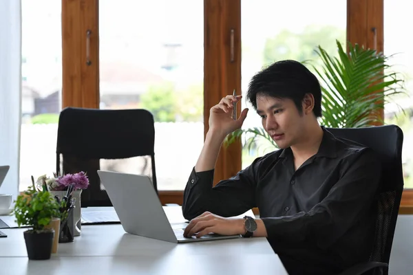 富有洞察力的亚洲商人在笔记本电脑上分析财务数据 — 图库照片