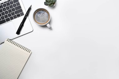 Minimal workplace with laptop computer, coffee cup, notepad and potted plant. Flat lay, Top view with copy space