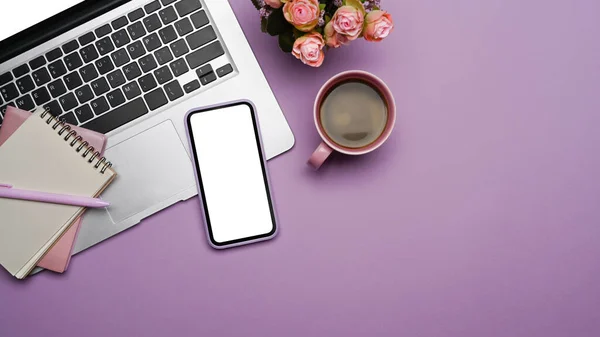 Mobile phone with blank screen, laptop computer and coffee cup on purple background. — Photo