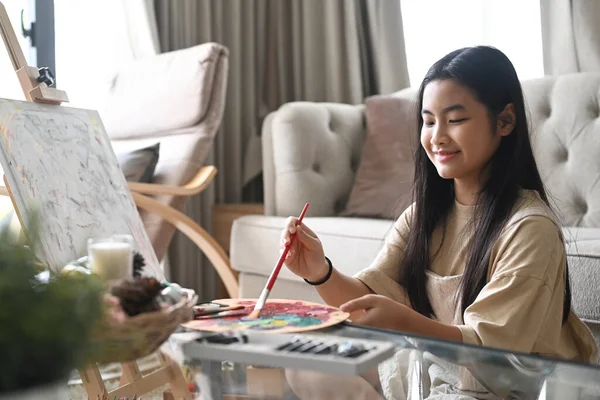 Menina bonito desfrutar de pintura imagem com aquarelas enquanto passar o tempo de lazer em casa. — Fotografia de Stock