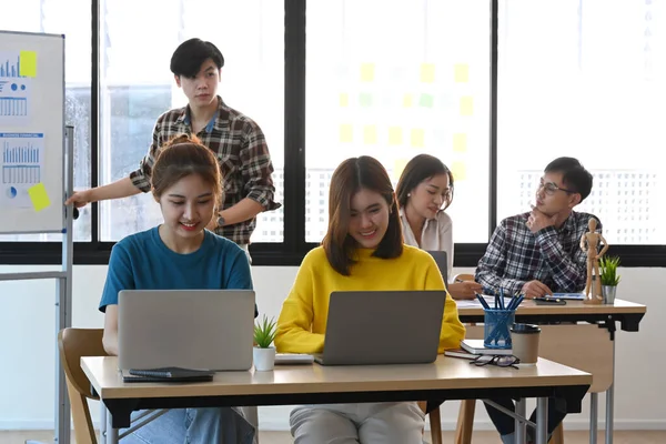 Les gens d'affaires en démarrage travaillent ensemble dans un bureau lumineux avec des appareils modernes. — Photo