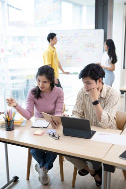 Bir grup yaratıcı insan modern ofiste yeni bir başlangıç projesi hakkında tartışıyorlar..