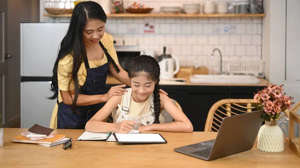 Asyalı Anne Tatlı Kızına Ödevi Yaparken Yardım Ediyor Mutfakta Internetten — Stok fotoğraf