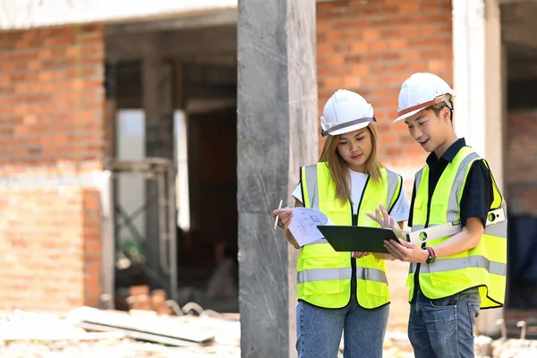 Civil engineers in safety helmet are meeting at construction site. Industry, Engineer, construction concept.