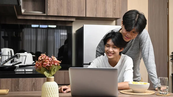 Adorable Gay Couple Spending Time Surfing Internet Laptop Together Kitchen — Stock Photo, Image