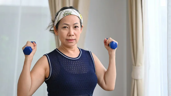 Sportif Son Sınıf Kadını Evde Dambıllarıyla Egzersiz Yapıyor Emeklilik Sağlıklı — Stok fotoğraf