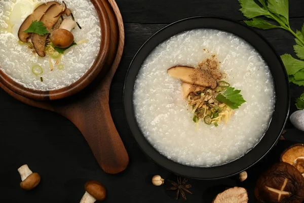 Delicious rice porridge with soft boiled egg, shiitake mushroom, slice ginger and scallion. Congee is a type of rice porridge or gruel popular in many Asian countries.