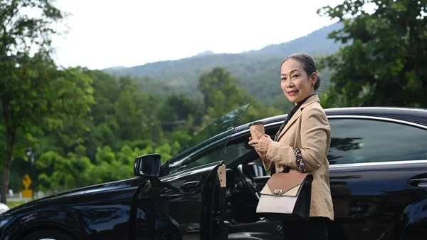 Mature Business Woman Standing Car Opened Door Smiling Camera — Foto Stock