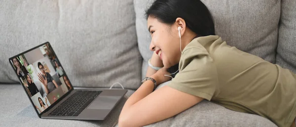 Cheerful Young Woman Communicating Video Conference Laptop While Lying Couch — Foto Stock