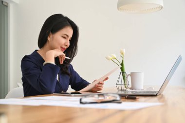 Professional young business woman working online with computer laptop in personal office.