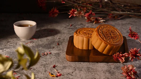 Chinese moon cake for Mid Autumn Festival on rustic stone background.