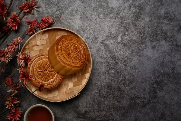 Chinese traditional mid autumn festival moon cake on rustic black background with copy space.