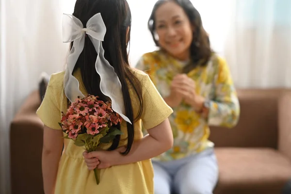 Little Grandchild Making Surprise Standing Bouquet Hands Excited Grandmother Sitting — Stock fotografie