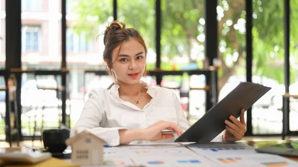 Confident Female Financial Advisor Sitting Her Office Preparing Contract Document — 스톡 사진