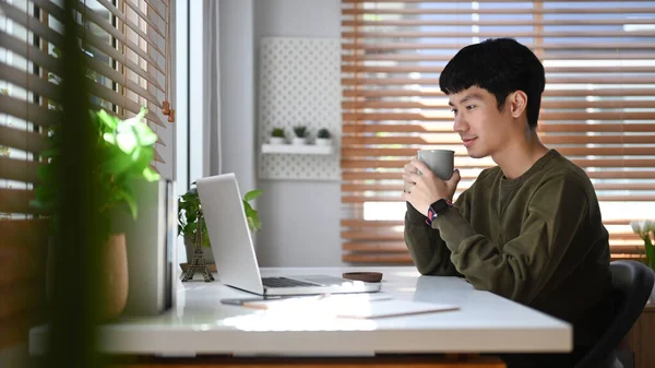 Focused Asian Businessman Watching Online Webinar Laptop Remote Working Home — Stockfoto