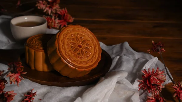 Tasty mooncakes for Mid autumn festival or Chinese traditional festival on wooden table.