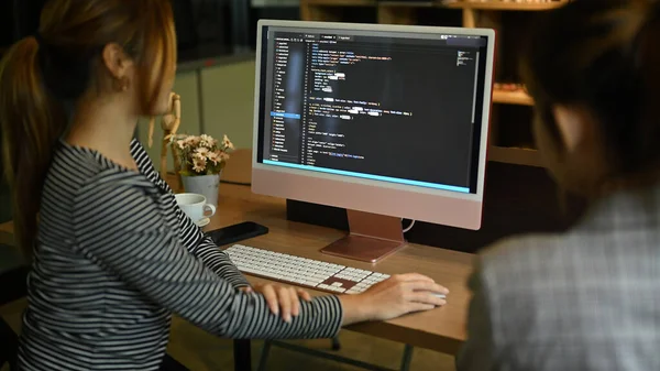 Two female software programmer working together for developing website design and coding technologies at office.