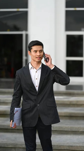 Handsome Businessman Black Suit Standing Modern Office Building Talking Mobile — Stock Fotó