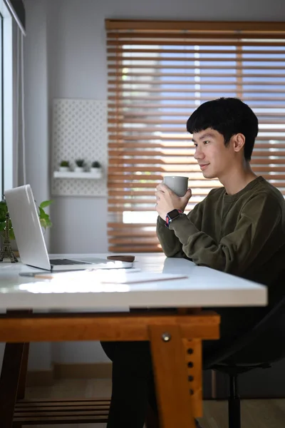 Asian Male Freelancer Drinking Coffee Reading Online Information Email Laptop — Foto de Stock
