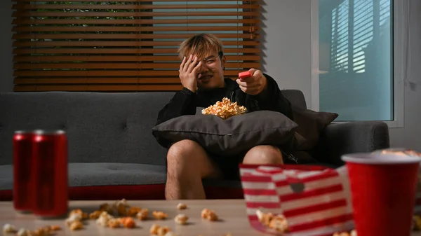 Frightened Asian Man Covering Face Hands While Watching Scary Movie — Stock fotografie
