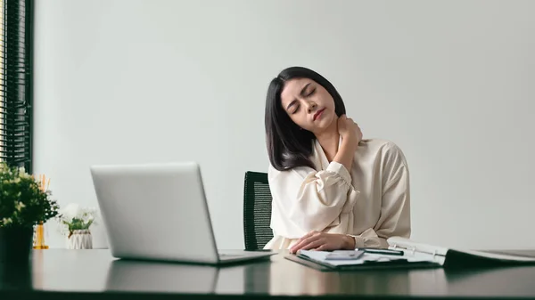 Tired Female Office Worker Massaging Her Neck Relieve Pain Sedentary — Φωτογραφία Αρχείου