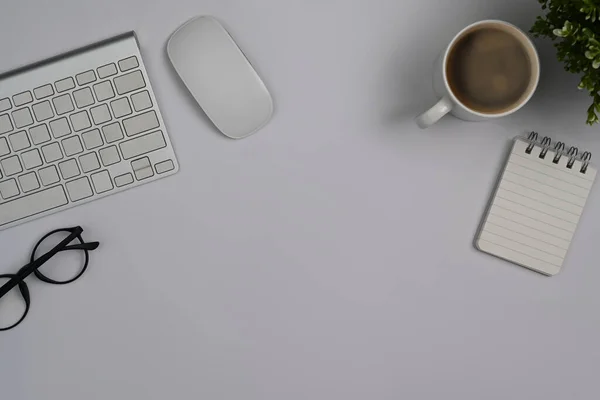 White Office Desk Eyeglasses Keyboard Coffee Cup Notebook Top View — Zdjęcie stockowe