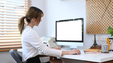 Side view creative woman working online, searching information on computer.