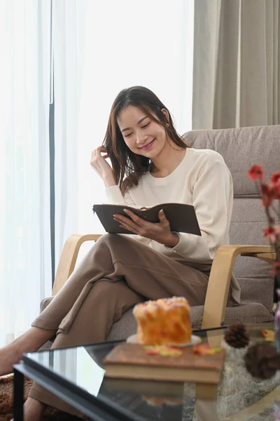 Satisfied Young Woman Reading Book Relaxing Comfortable Armchair Home Leisure — Fotografia de Stock
