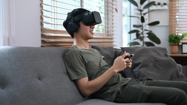 Joyful Asian Male Experiencing Opportunities Gaming Virtual Reality Headset Relaxing — Stock Fotó