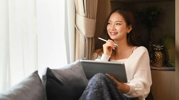 Satisfied Woman Holding Tablet Looking Window Spending Leisure Time Home — Zdjęcie stockowe