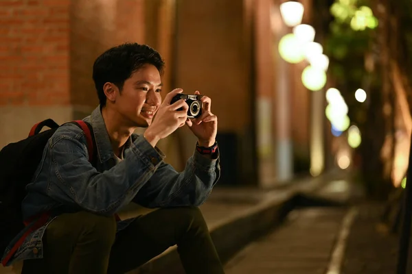 Young Male Traveler Taking Photo His Camera Sitting Stairs Night —  Fotos de Stock