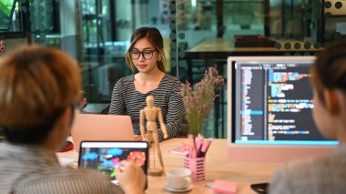 Group of professional it developer brainstorming, working with coded data in corporate office.