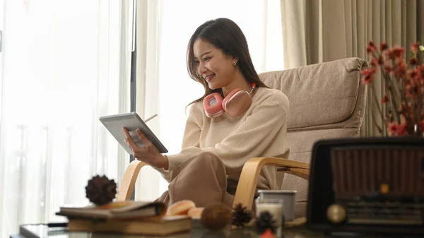 Satisfied Young Female Surfing Internet Digital Tablet Relaxing Armchair Home — 图库照片