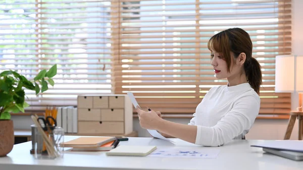 Pretty Young Woman White Sweater Reading Document Using Laptop Working — Fotografia de Stock