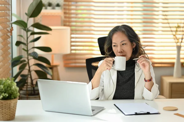 Pleasant Middle Aged Businesswoman Drinking Coffee Working Laptop Home — Foto de Stock