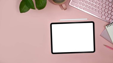 Feminine office desk with digital tablet, notebook, coffee cup and houseplant. Flat lay, top view with copy space.