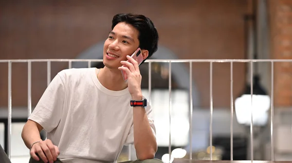 Young Asian Man Having Phone Conversation While Sitting Contemporary Cafe — Foto Stock