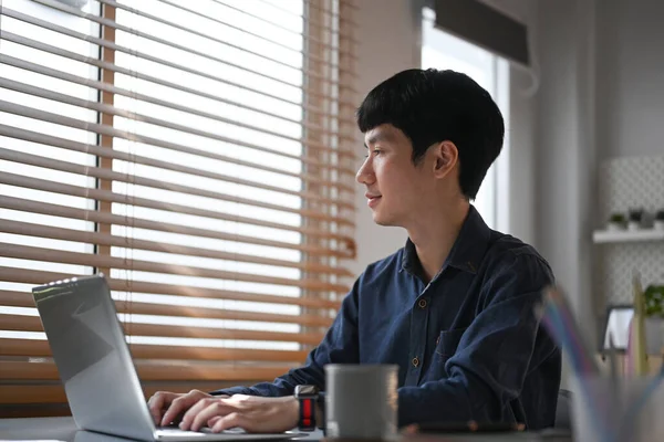 Thoughtful Young Businessman Typing Business Email Working Laptop Comfortable Home — Zdjęcie stockowe