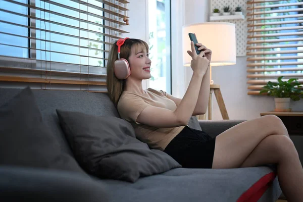 Cheerful Young Woman Using Mobile Phone While Resting Couch Spending — 스톡 사진