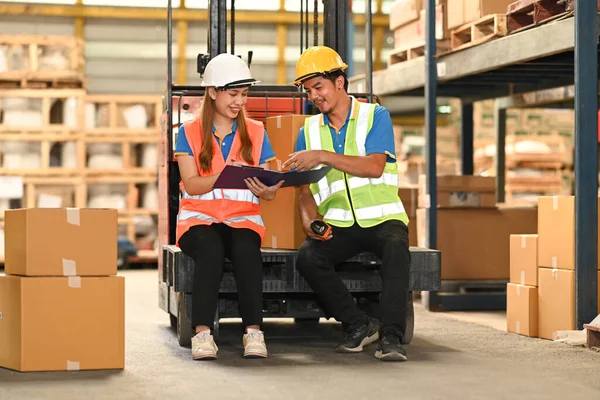 Two Happy Warehouse Worker Sitting Forklift Truck Checks Stock Inventory — Stock fotografie