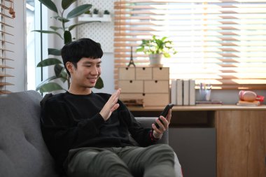 Man making video call, having virtual chat on smart phone from home. Technology, social network, communication concept.