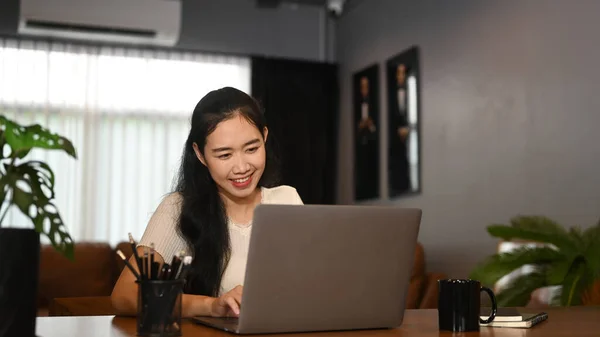 Cheerful Female Freelancer Using Laptop Her Contemporary Home Office — Fotografia de Stock